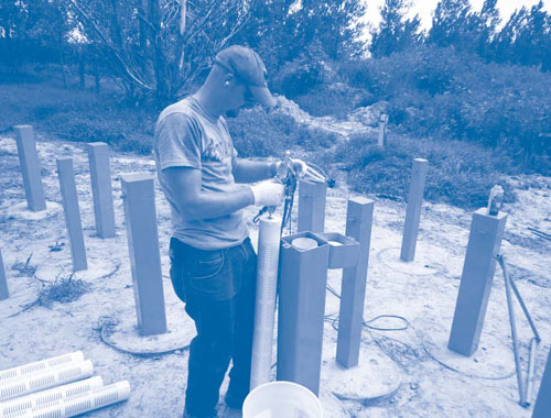 Figure 2. As part of ISCO implementation at the former Cozad landfill, five 3-foot KMnO4/paraffin candles were vertically stacked in a slotted holder and lowered into each of ten groundwater wells.