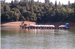 Barge delivery of sacks filed with organic media or other construction materials such as drainage gravel and rip rap needed for the Golinsky Mine BCR