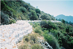 Construction materials stockpiled along a quarry access road near the Golinsky Mine