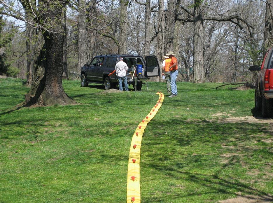Figure 6. USGS hydrologists conduct a seismic imaging survey. The yellow land streamer contains the geophones (red) and is towed behind a vehicle. This relatively new system allows for inexpensive and rapid data acquisition. The survey was conducted as part of an applied research effort by the USGS Office of Groundwater Branch of Geophysics in the Bronx, New York, in 2007 (USGS, 2007).